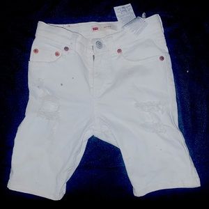 A pair of ripped white Levi kids jean shorts